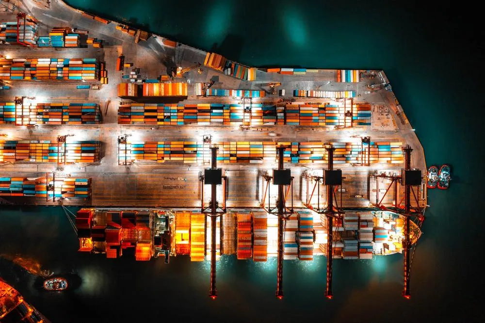 Shipping containers unloading at a port in the night