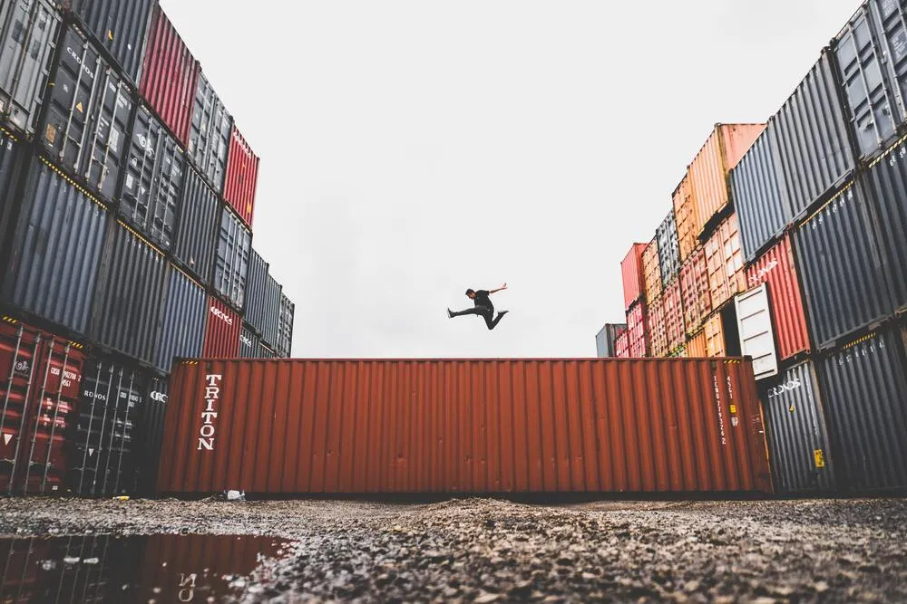 Man leaps over shipping container