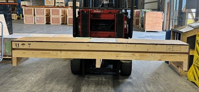Wide wooden crate containing spare parts ready for air freight to India