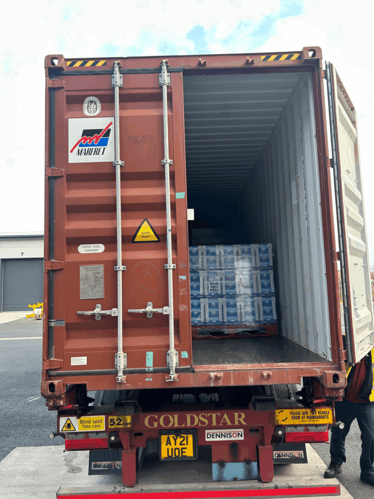 Open shipping container on the back of a truck, loaded for shipping FCL to Trinidad