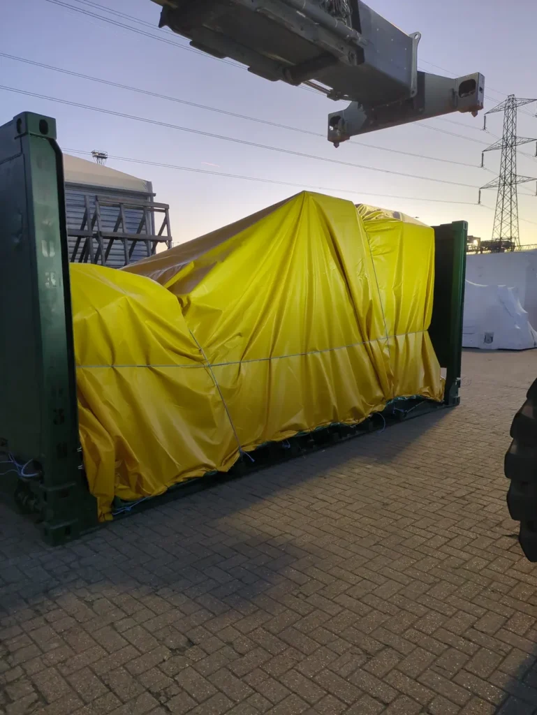 20' flat rack container with yellow tarpaulin sheeting secured for out of gauee shipping to USA