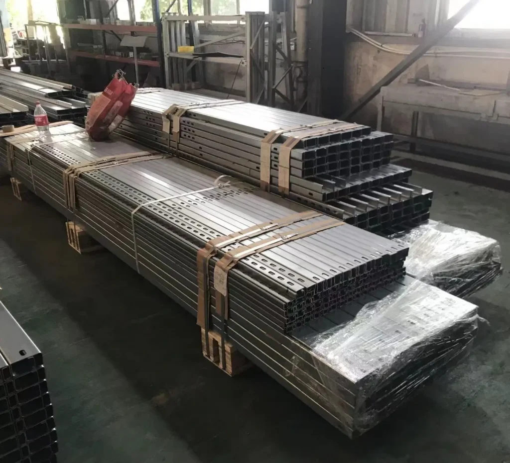 Lengths of metal strapped to pallets in a warehouse for air freight from China to the UK