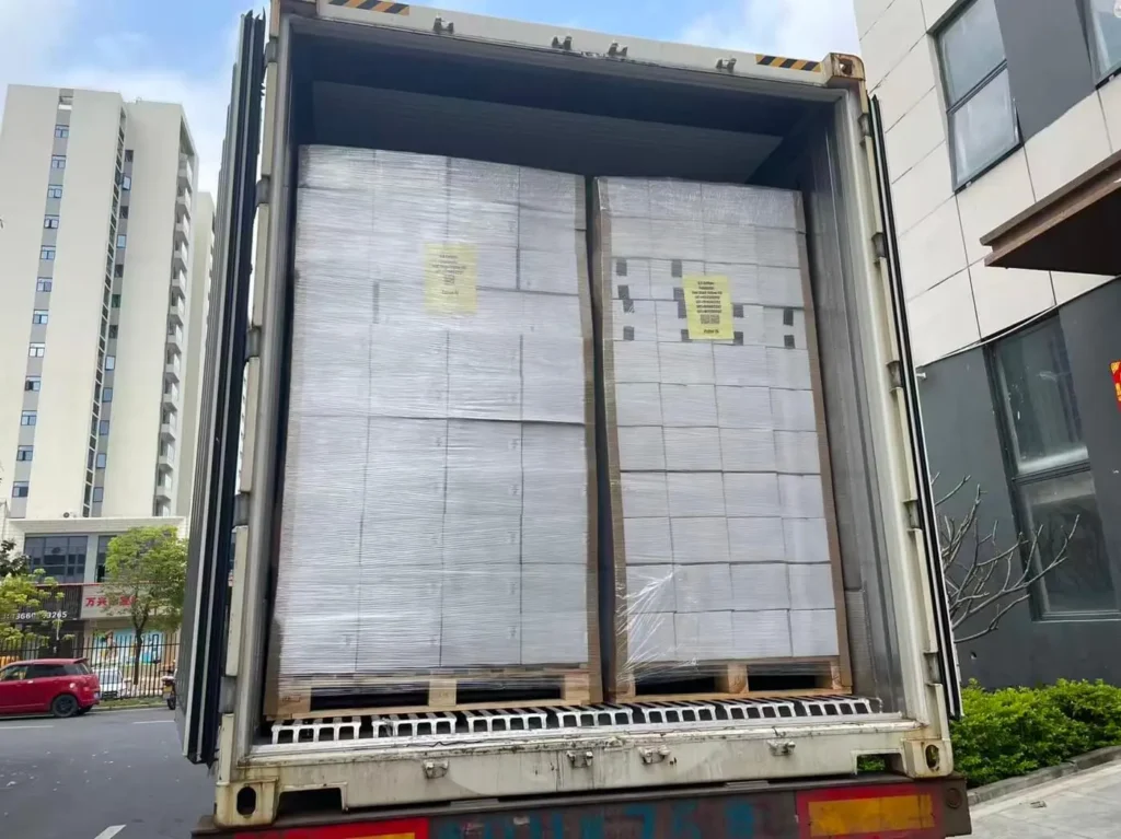 Shipping container loaded with pallets, doors open, freight forwarder from China