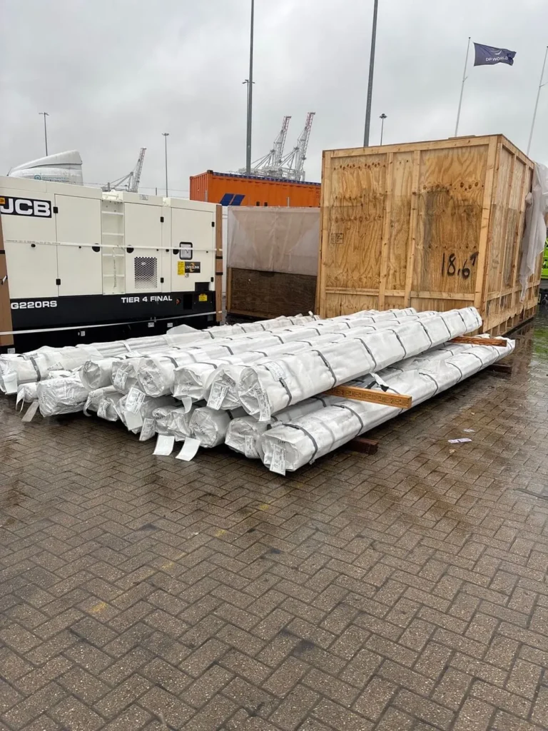 Stainless steel tubes stacked on a port quay, devanned, ready for UK import delivery